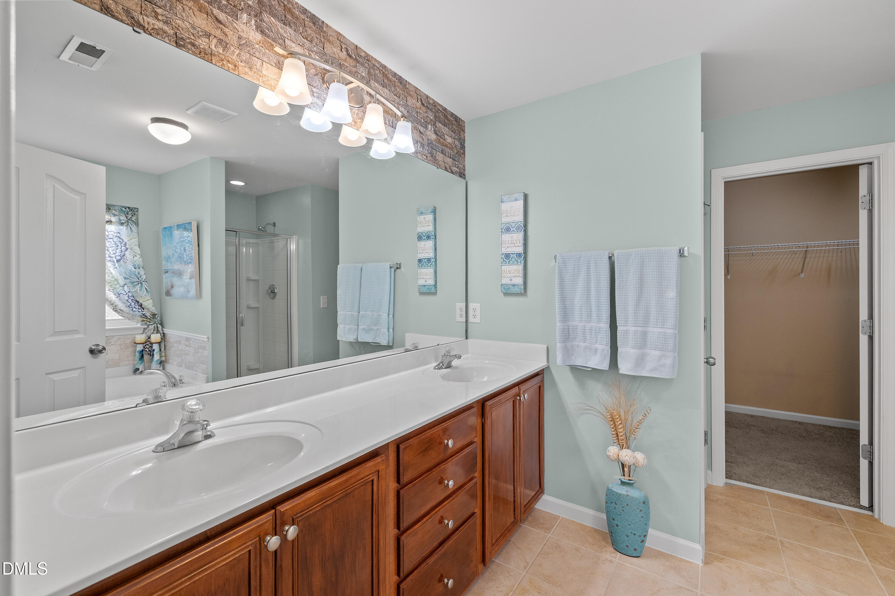 7837 Cape Charles Drive Raleigh, NC 27617 - Photo 21 of 43 a spacious bathroom with a double vanity sink mirror and double