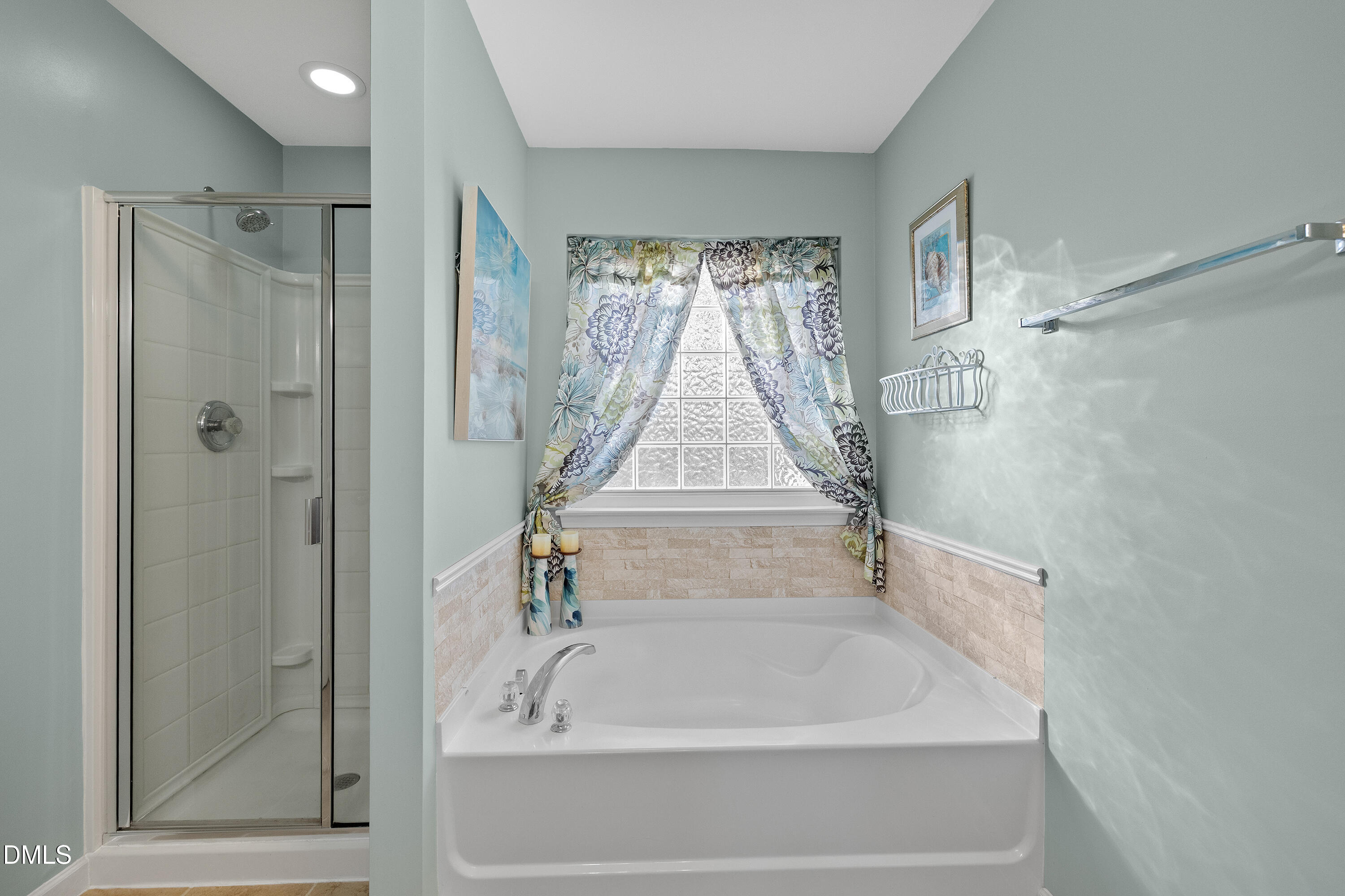 7837 Cape Charles Drive Raleigh, NC 27617 - Photo 22 of 43 a white bath tub sitting next to a shower