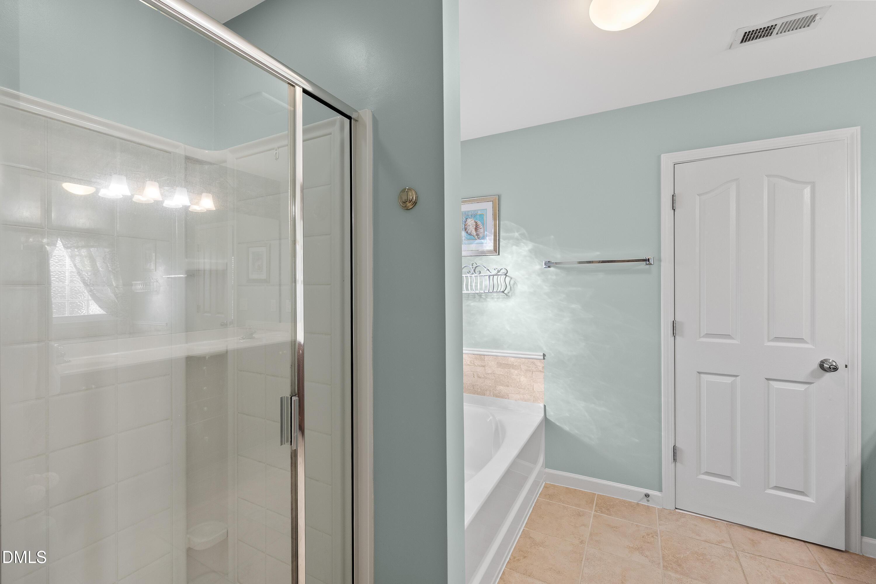 7837 Cape Charles Drive Raleigh, NC 27617 - Photo 23 of 43 a bathroom with a glass shower door
