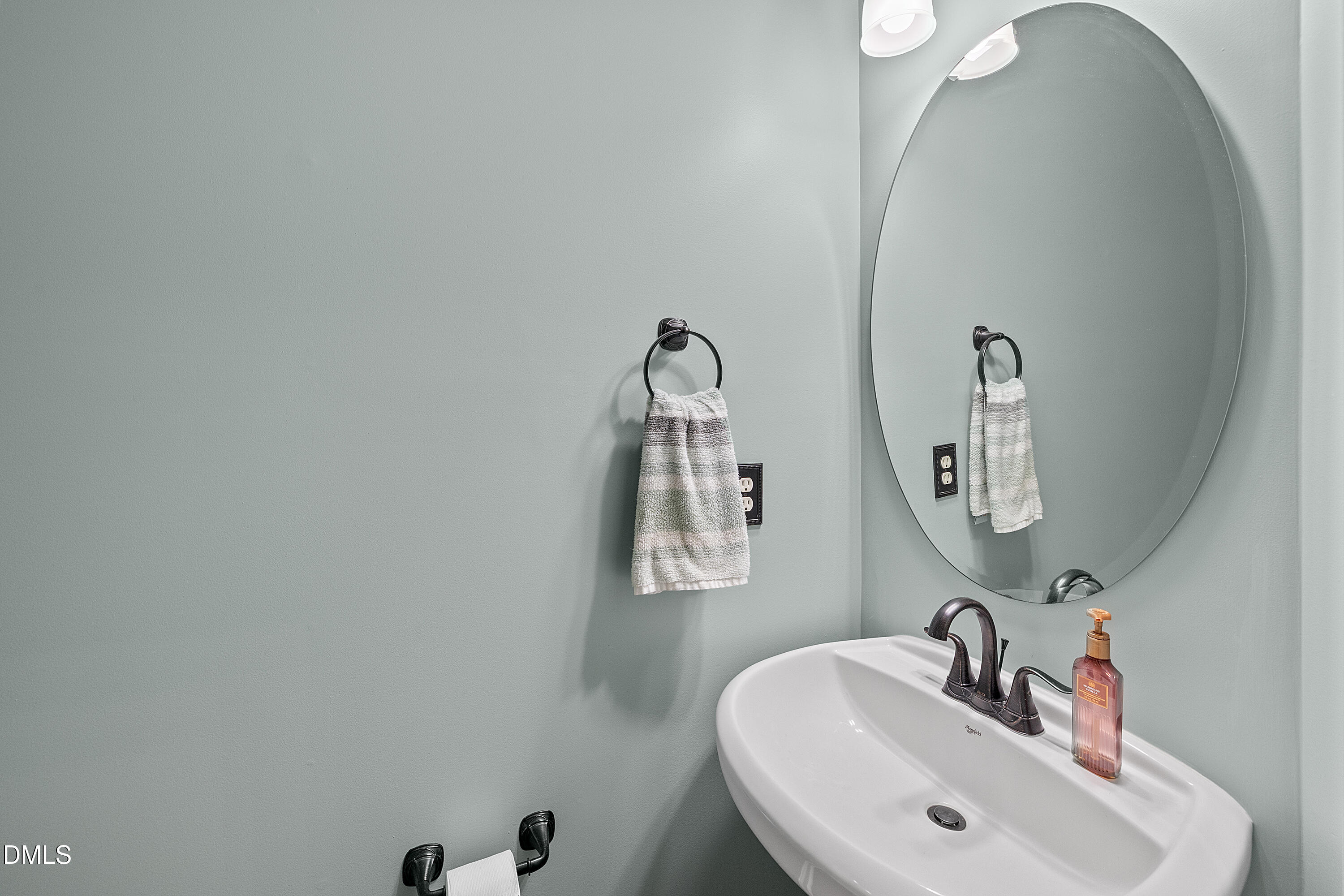 7837 Cape Charles Drive Raleigh, NC 27617 - Photo 30 of 43 a bathroom with a sink and a mirror