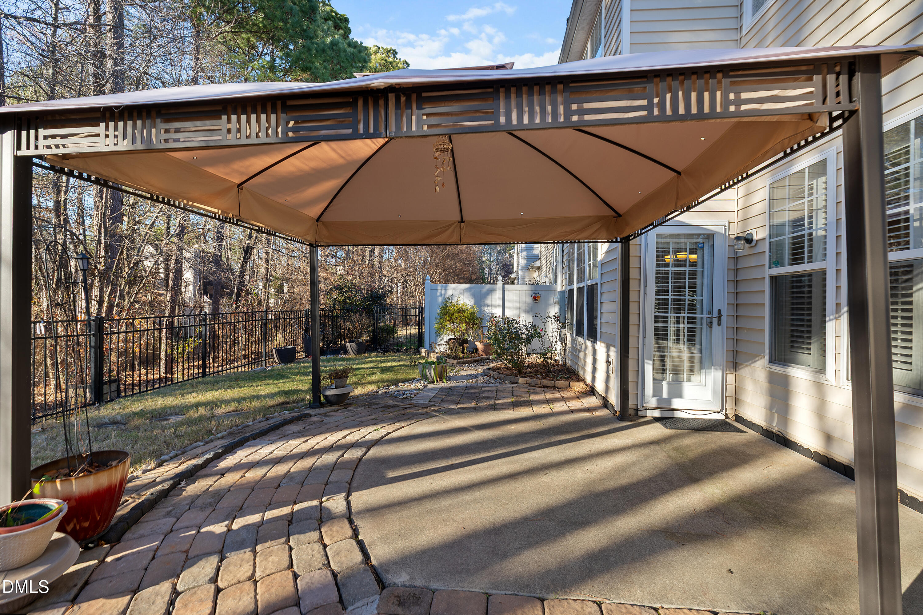 7837 Cape Charles Drive Raleigh, NC 27617 - Photo 38 of 43 a view of patio with a table and chairs under an umbrella