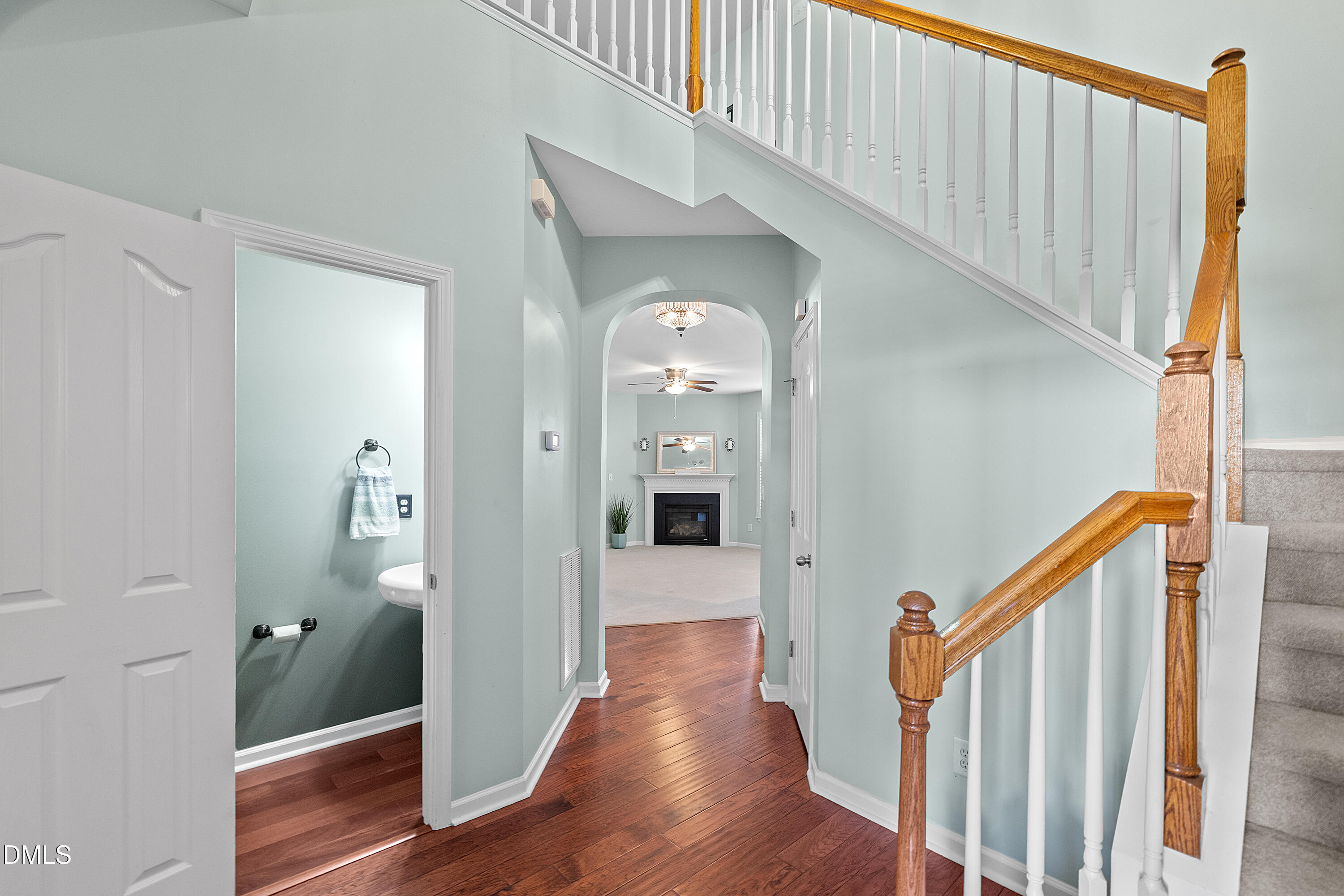 7837 Cape Charles Drive Raleigh, NC 27617 - Photo 4 of 43 a view of a hallway view with wooden floor and staircase