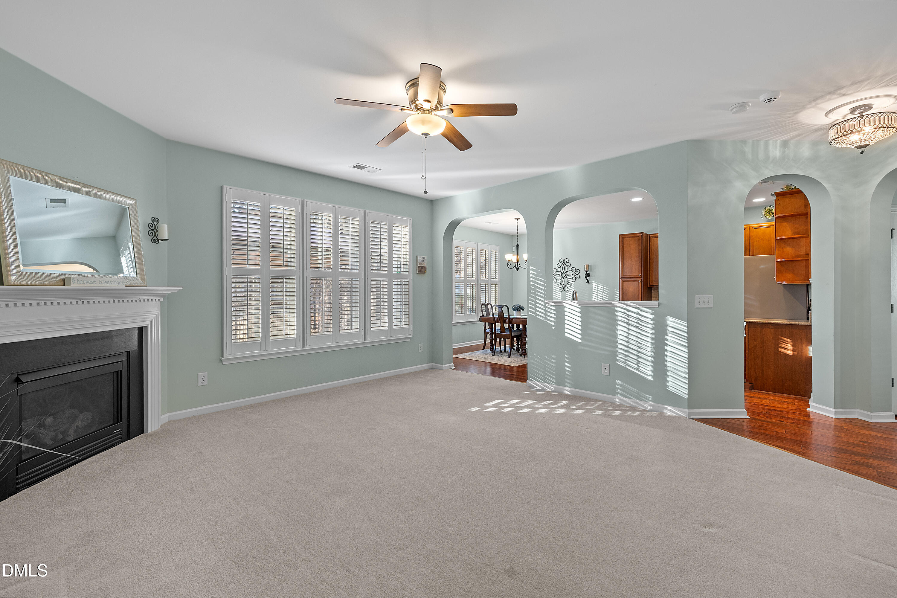 7837 Cape Charles Drive Raleigh, NC 27617 - Photo 9 of 43 a view of empty room with a fireplace and fan