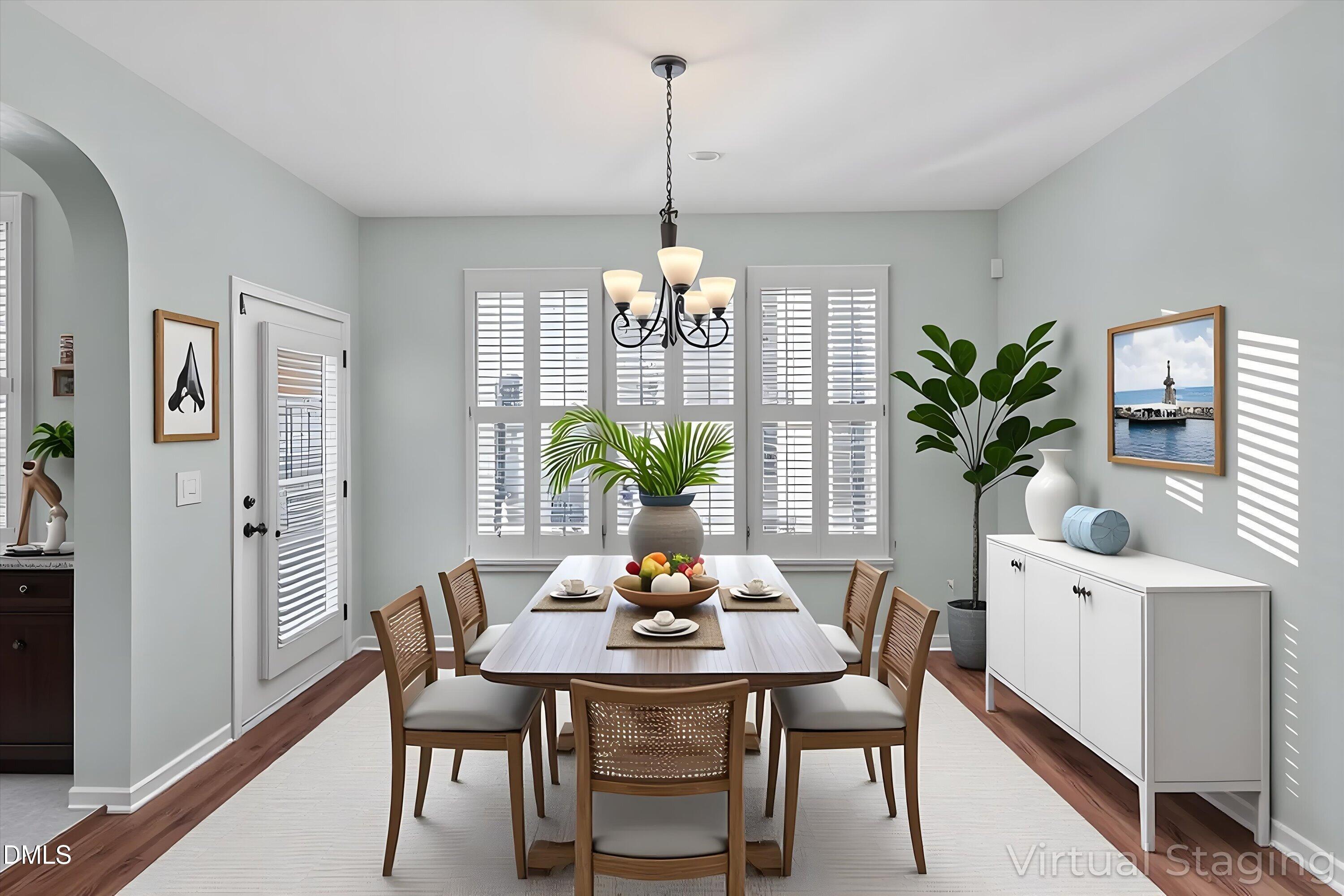 7837 Cape Charles Drive Raleigh, NC 27617 - Photo 9 of 44 a dining room with furniture potted plants and wooden floor