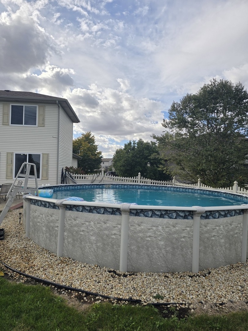 1514 Spring Oaks Drive Joliet, IL 60431 - Photo 26 of 35 a view of a swimming pool with a yard