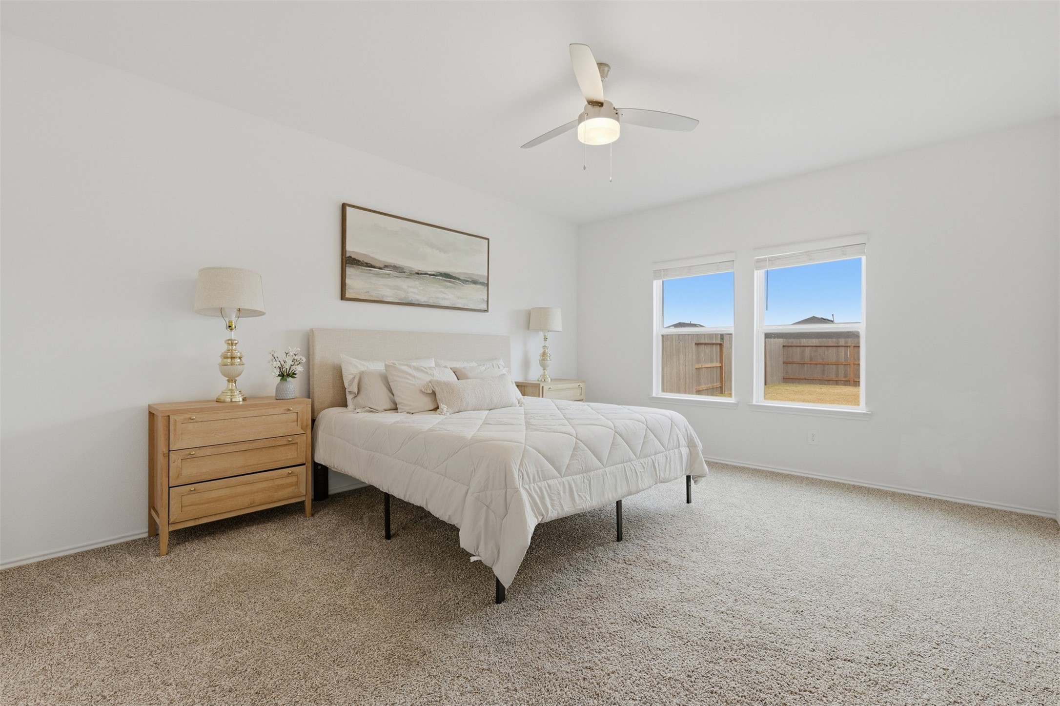 17719 Winfall Drive Crosby, TX 77532 - Photo 18 of 47 Bright and spacious primary bedroom with neutral decor and large windows offering natural light and a view of the backyard.
