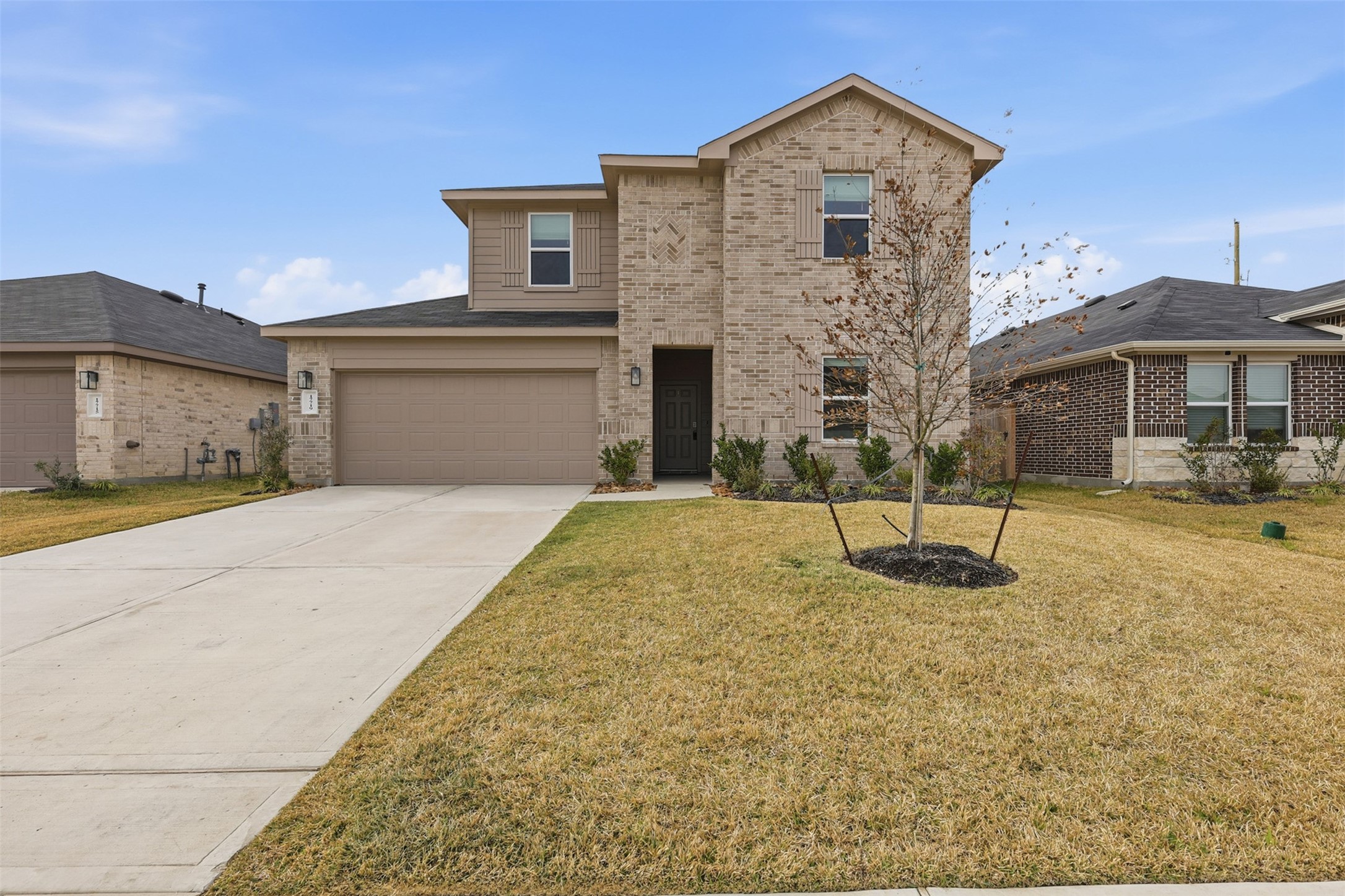 17719 Winfall Drive Crosby, TX 77532 - Photo 2 of 47 Modern two-story brick home with a double garage and well-maintained front yard. Spacious driveway and a young tree enhance curb appeal. Quiet neighborhood setting.