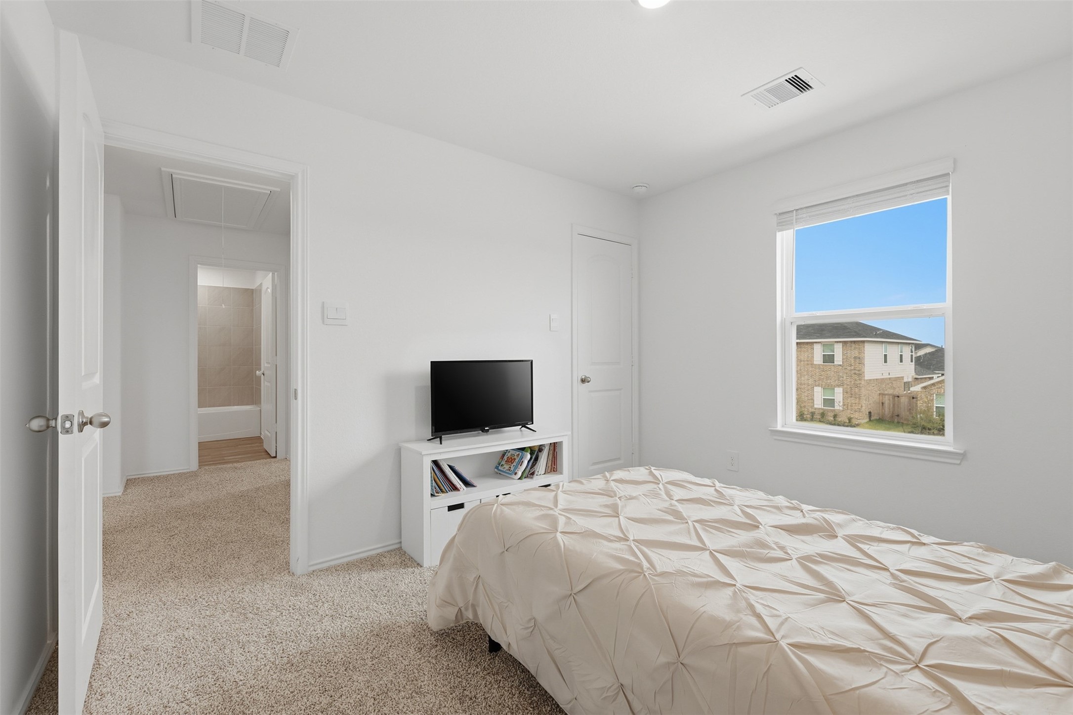 17719 Winfall Drive Crosby, TX 77532 - Photo 26 of 47 This cozy secondary bedroom features soft carpet and a window providing natural light and a view of the neighborhood.