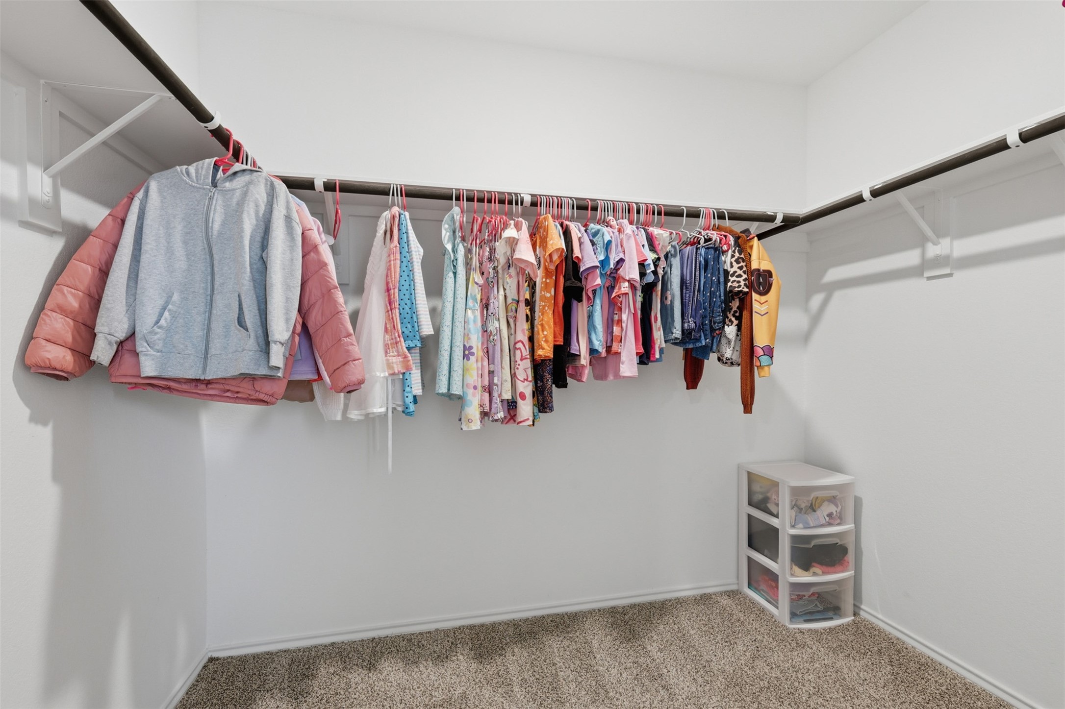 17719 Winfall Drive Crosby, TX 77532 - Photo 28 of 47 Spacious walk-in closet with hanging rods on two sides, perfect for organizing clothes.