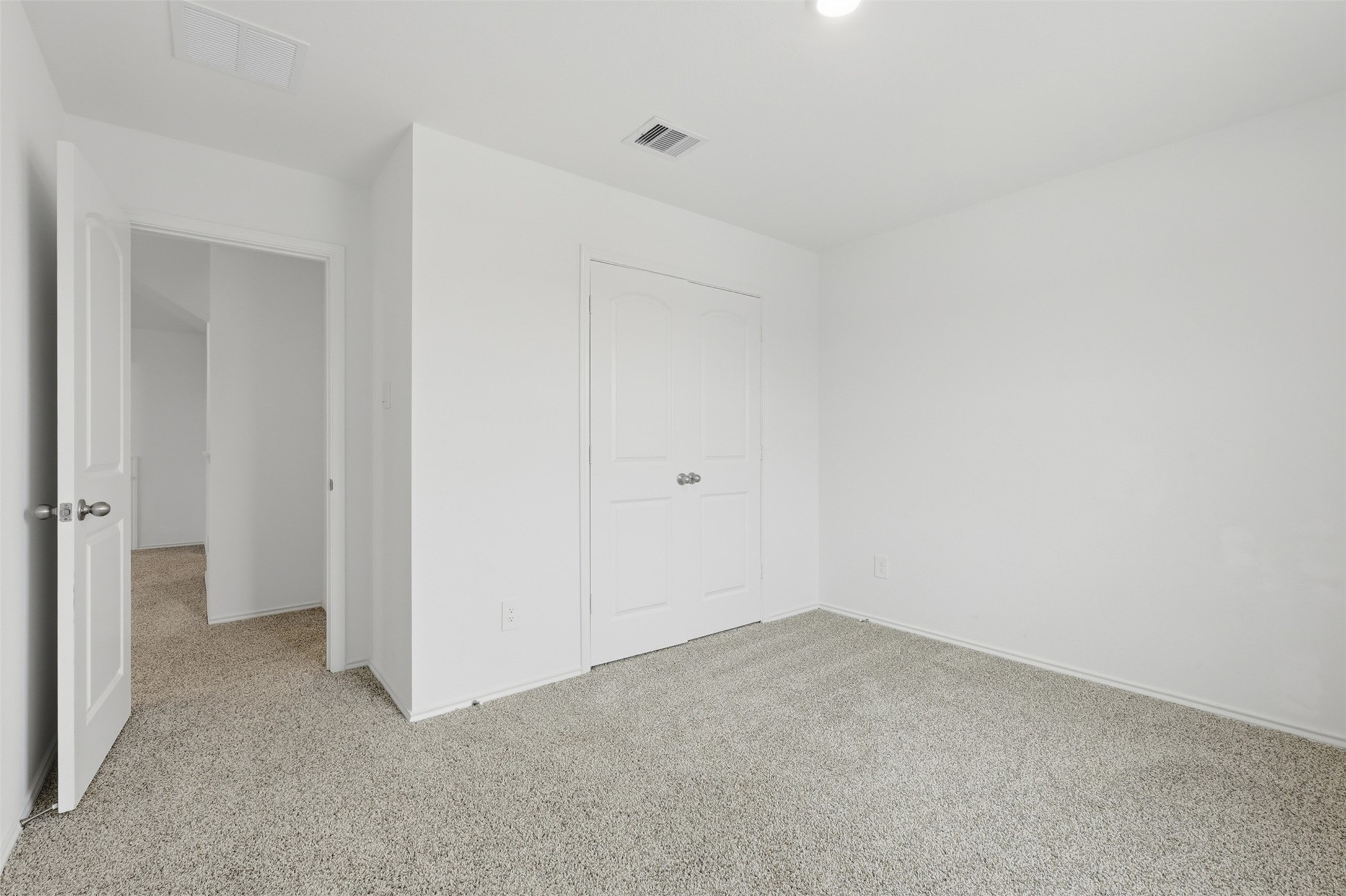 17719 Winfall Drive Crosby, TX 77532 - Photo 32 of 47 A bright fourth bedroom with neutral walls and carpeted flooring, featuring a single window with a view of neighboring houses.
