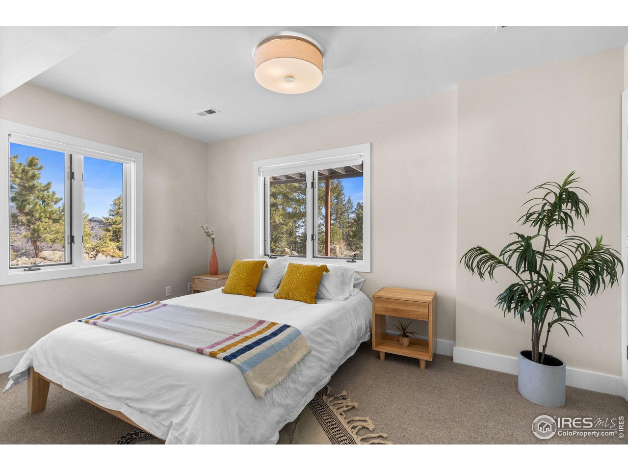 1346 Deer Trail Road Boulder, CO 80302 - Photo 27 of 40 a bedroom with a bed and a large window