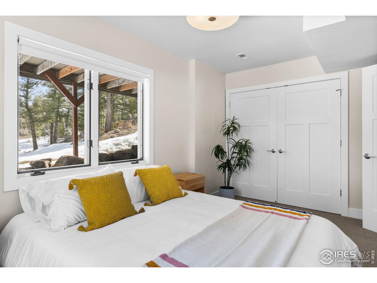 1346 Deer Trail Road Boulder, CO 80302 - Photo 28 of 40 a bedroom with a large bed and a large window