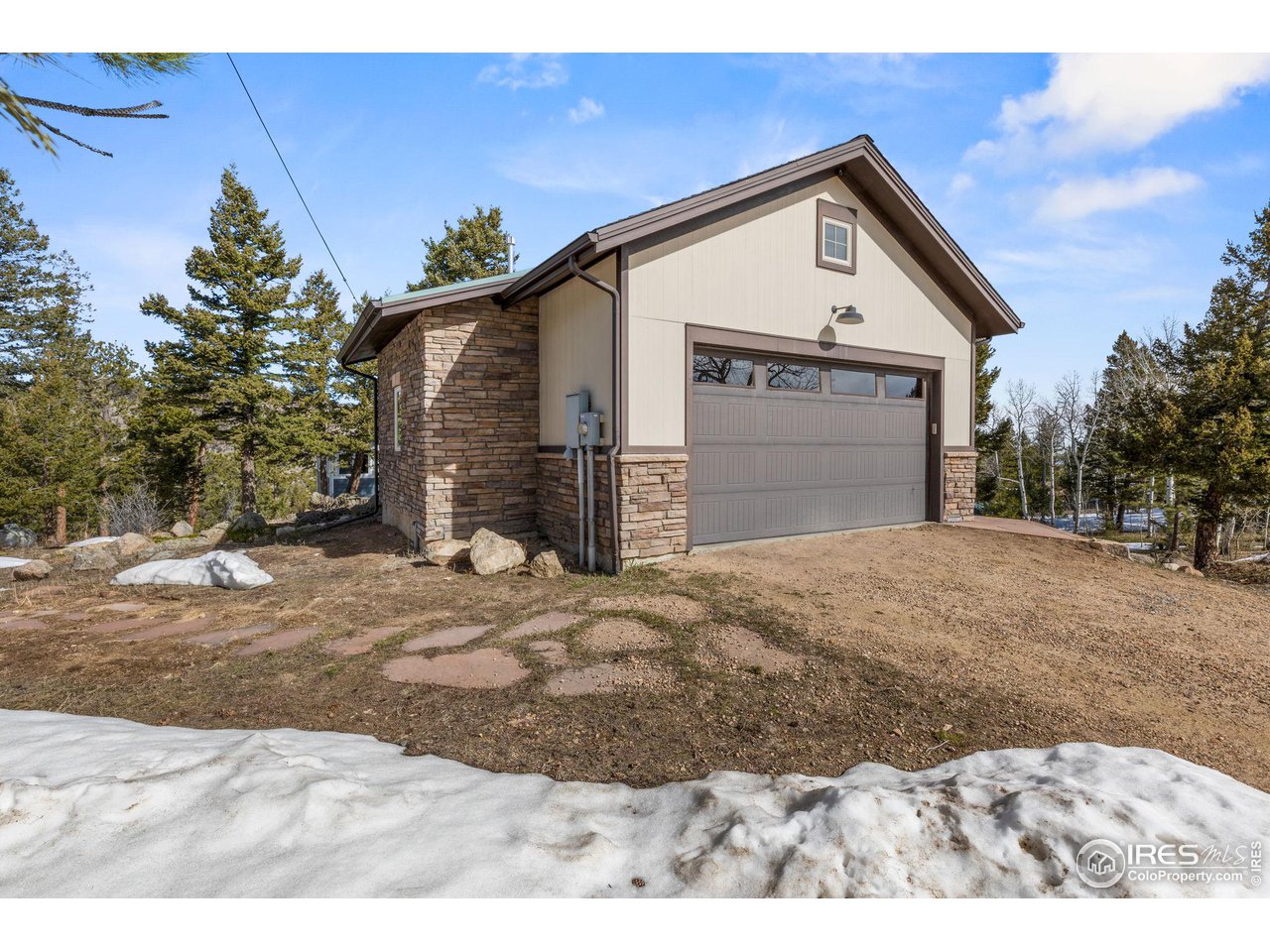 1346 Deer Trail Road Boulder, CO 80302 - Photo 37 of 40 a front view of a house with a yard and garage