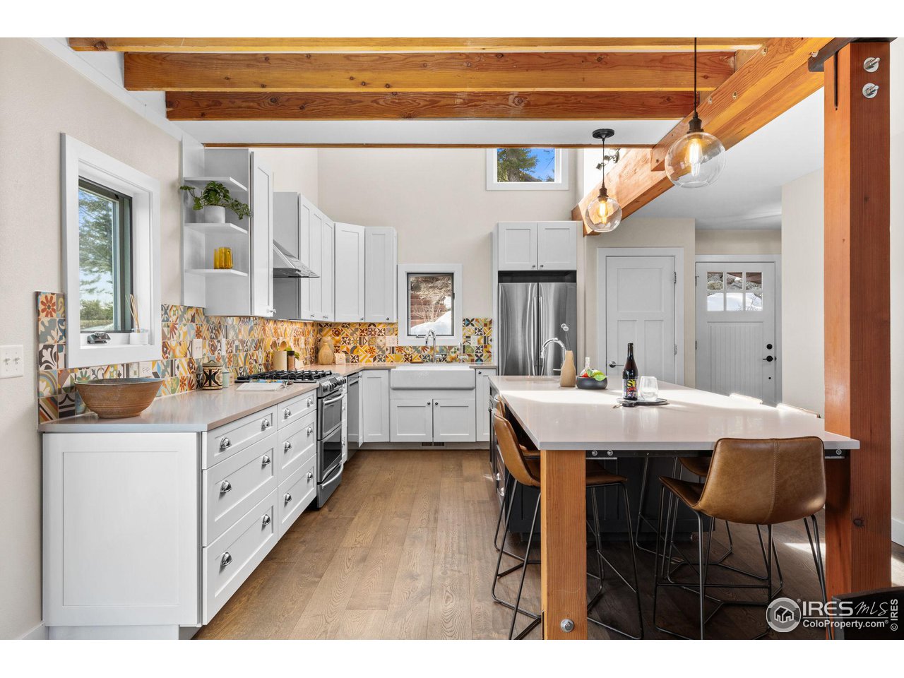 1346 Deer Trail Road Boulder, CO 80302 - Photo 8 of 40 a kitchen with stainless steel appliances kitchen island granite countertop a sink and cabinets