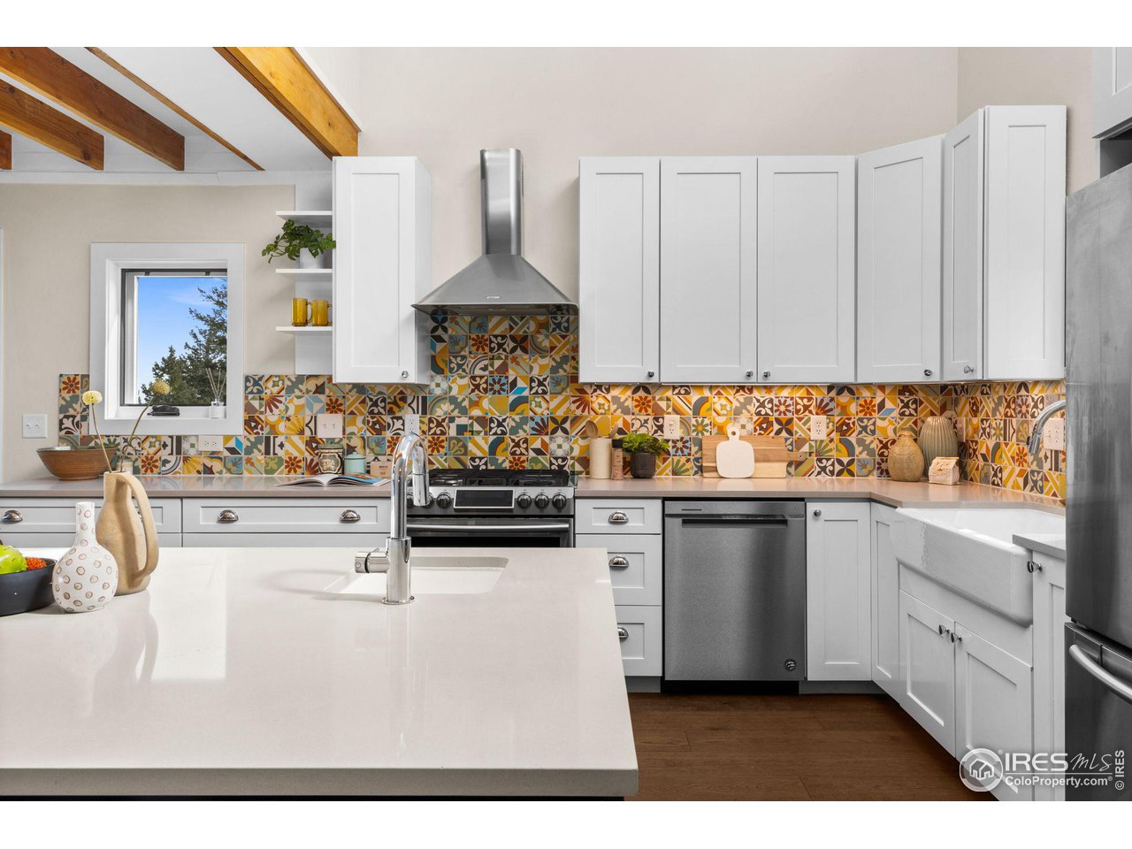 1346 Deer Trail Road Boulder, CO 80302 - Photo 9 of 40 a kitchen with stainless steel appliances kitchen island granite countertop a sink stove and cabinets