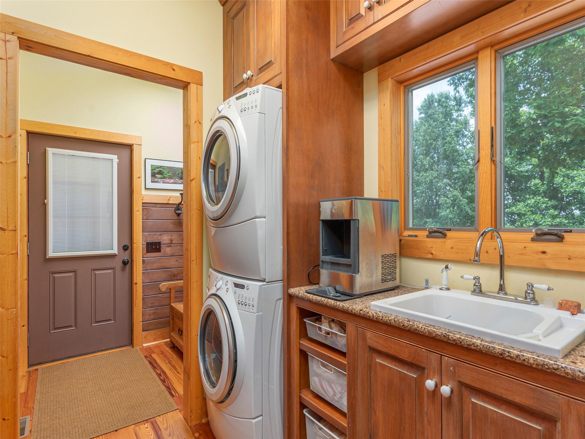120 Skyridge Drive Clyde, NC 28721 - Photo 15 of 33 a bathroom with a sink a washer and dryer next to a window