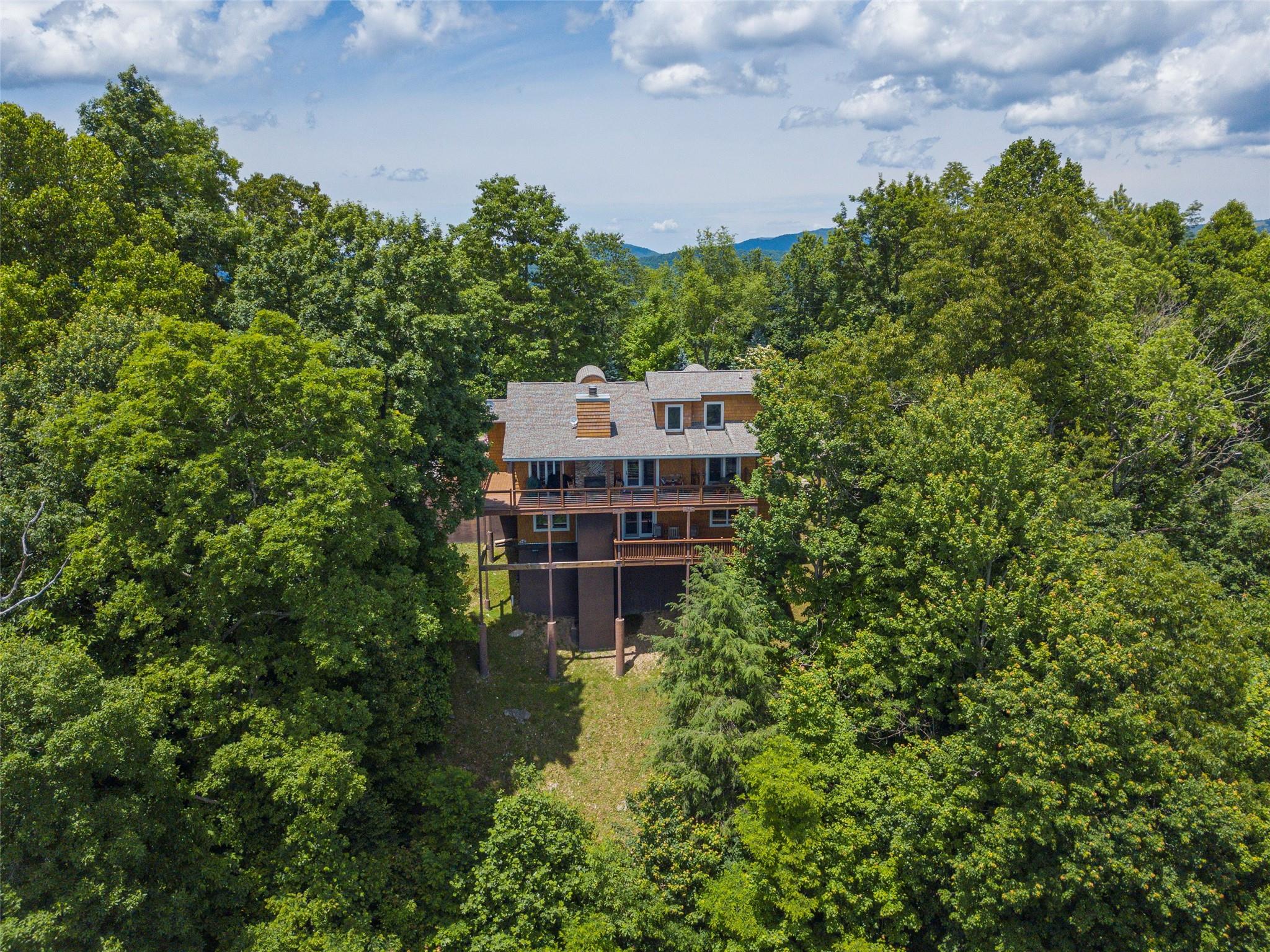 120 Skyridge Drive Clyde, NC 28721 - Photo 2 of 33 a view of a large building with a tree and a big yard