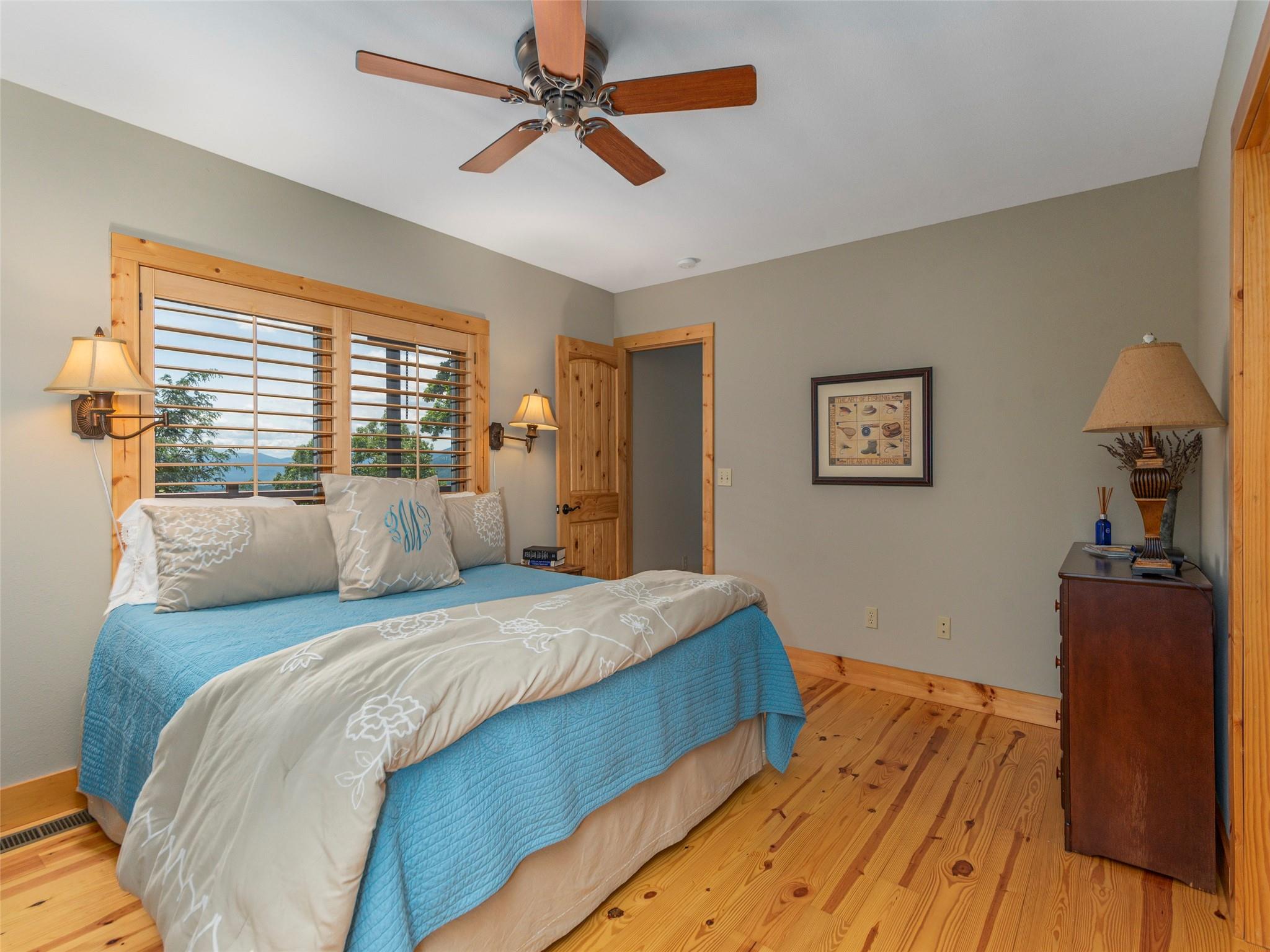 120 Skyridge Drive Clyde, NC 28721 - Photo 24 of 33 a bedroom with a bed and wooden floor