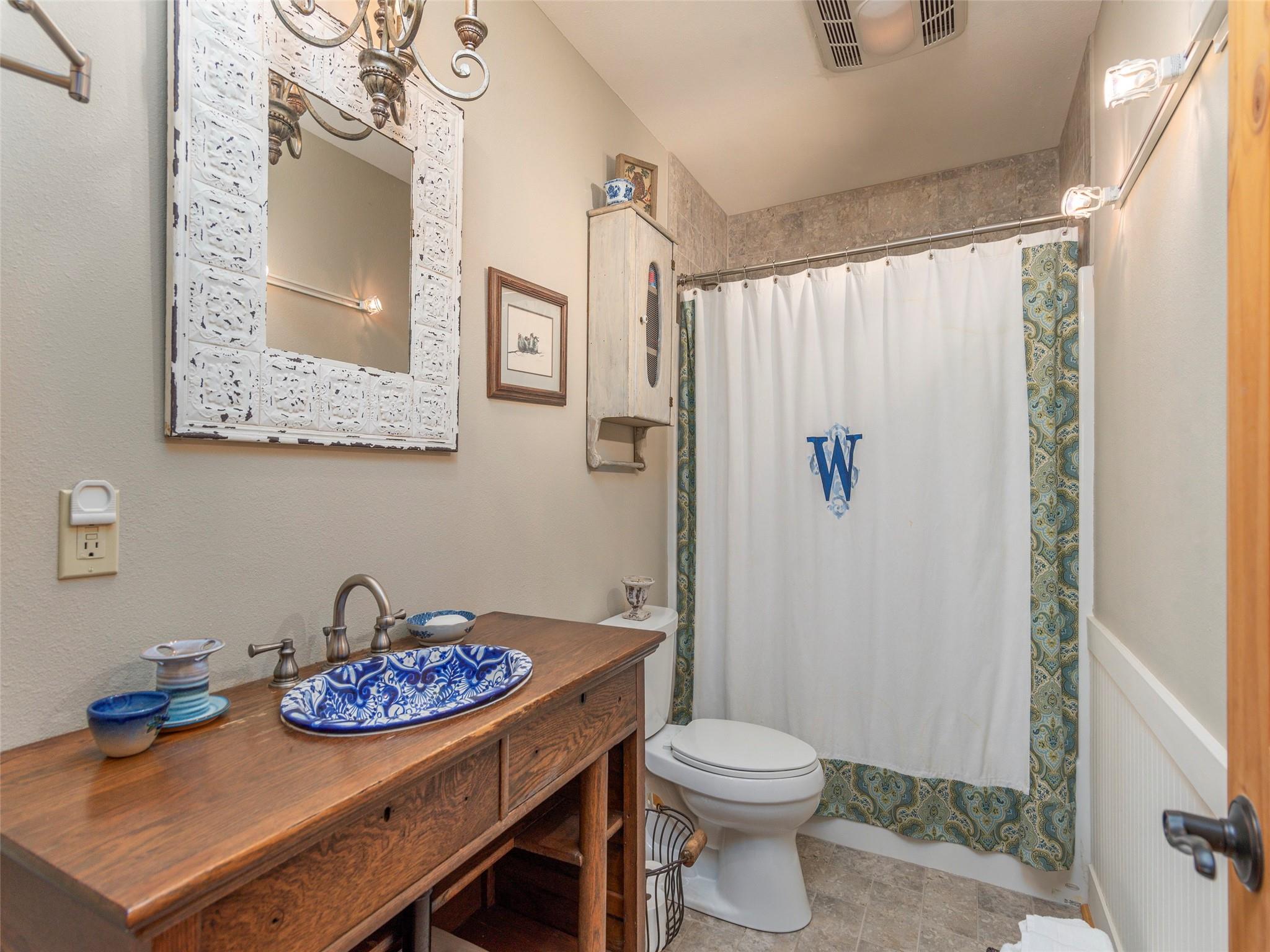 120 Skyridge Drive Clyde, NC 28721 - Photo 25 of 33 a bathroom with a sink a toilet and shower curtain