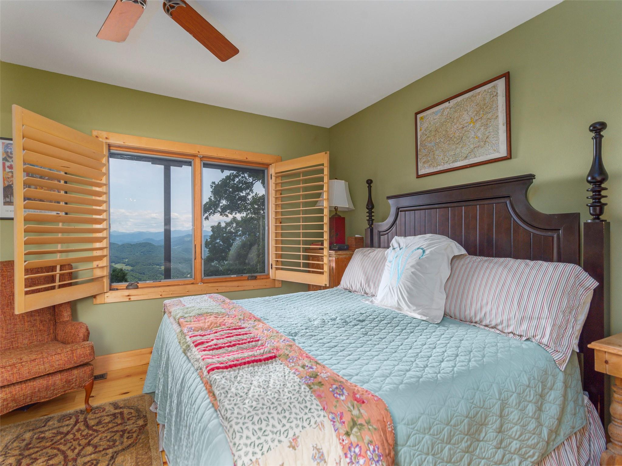 120 Skyridge Drive Clyde, NC 28721 - Photo 27 of 33 a bedroom with a bed and glass window