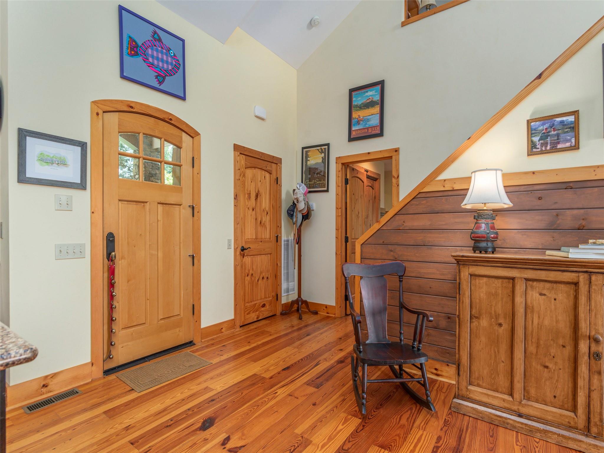 120 Skyridge Drive Clyde, NC 28721 - Photo 6 of 33 a view of a hallway with wooden floor and staircase