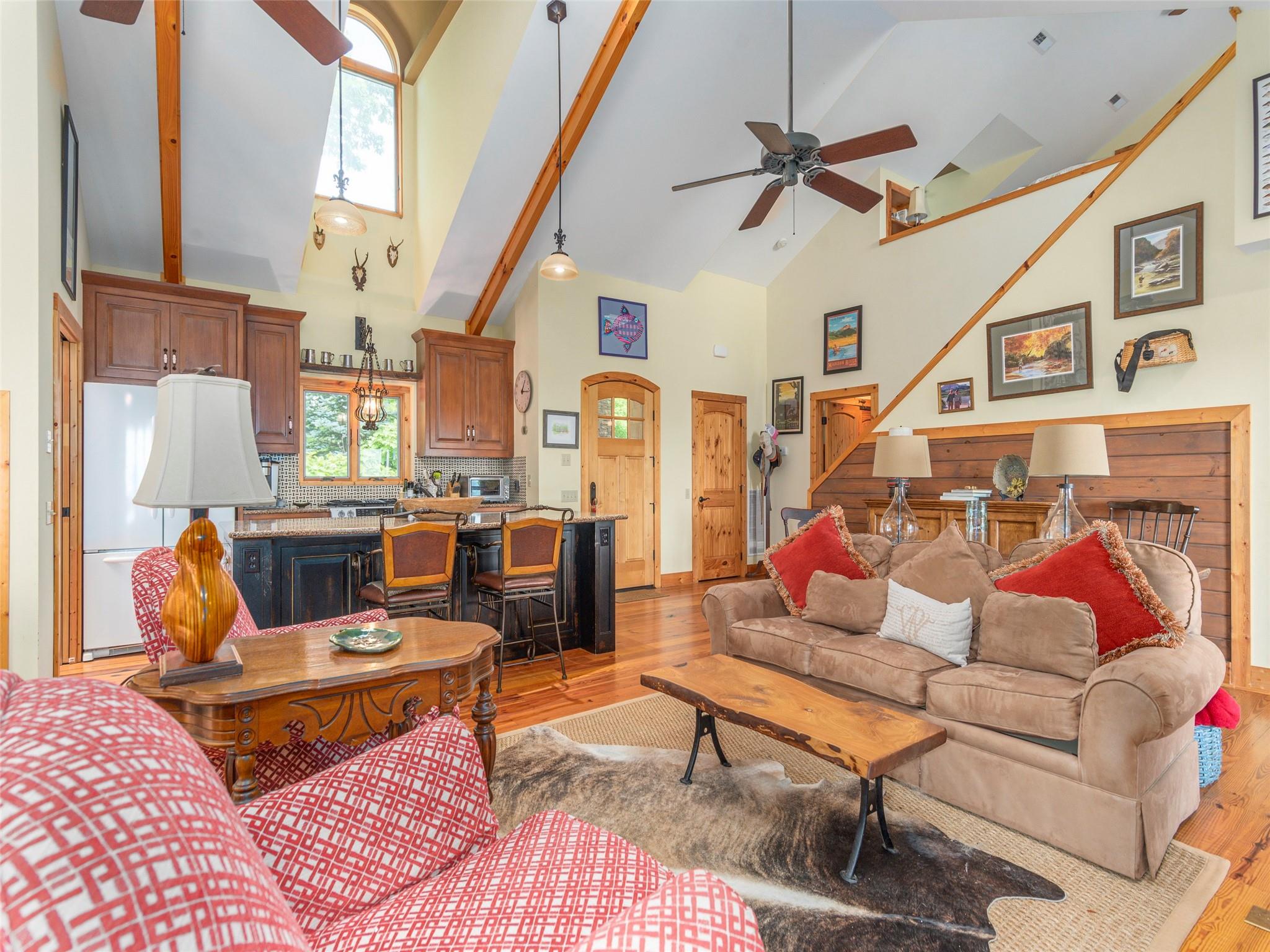120 Skyridge Drive Clyde, NC 28721 - Photo 8 of 33 a living room with furniture a rug and a chandelier