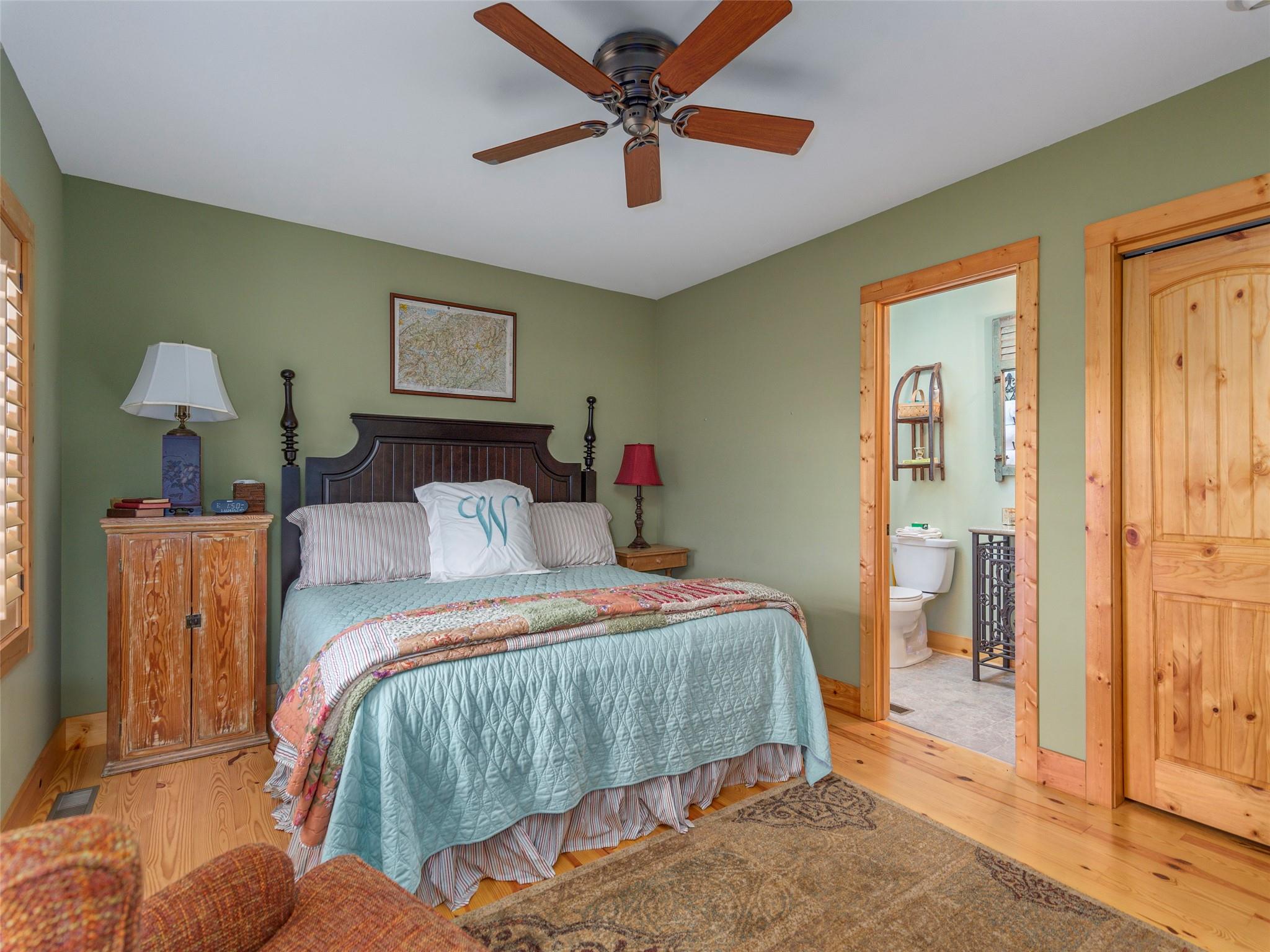 120 Skyridge Drive Clyde, NC 28721 - Photo 10 of 33 a bedroom with a bed and a chandelier