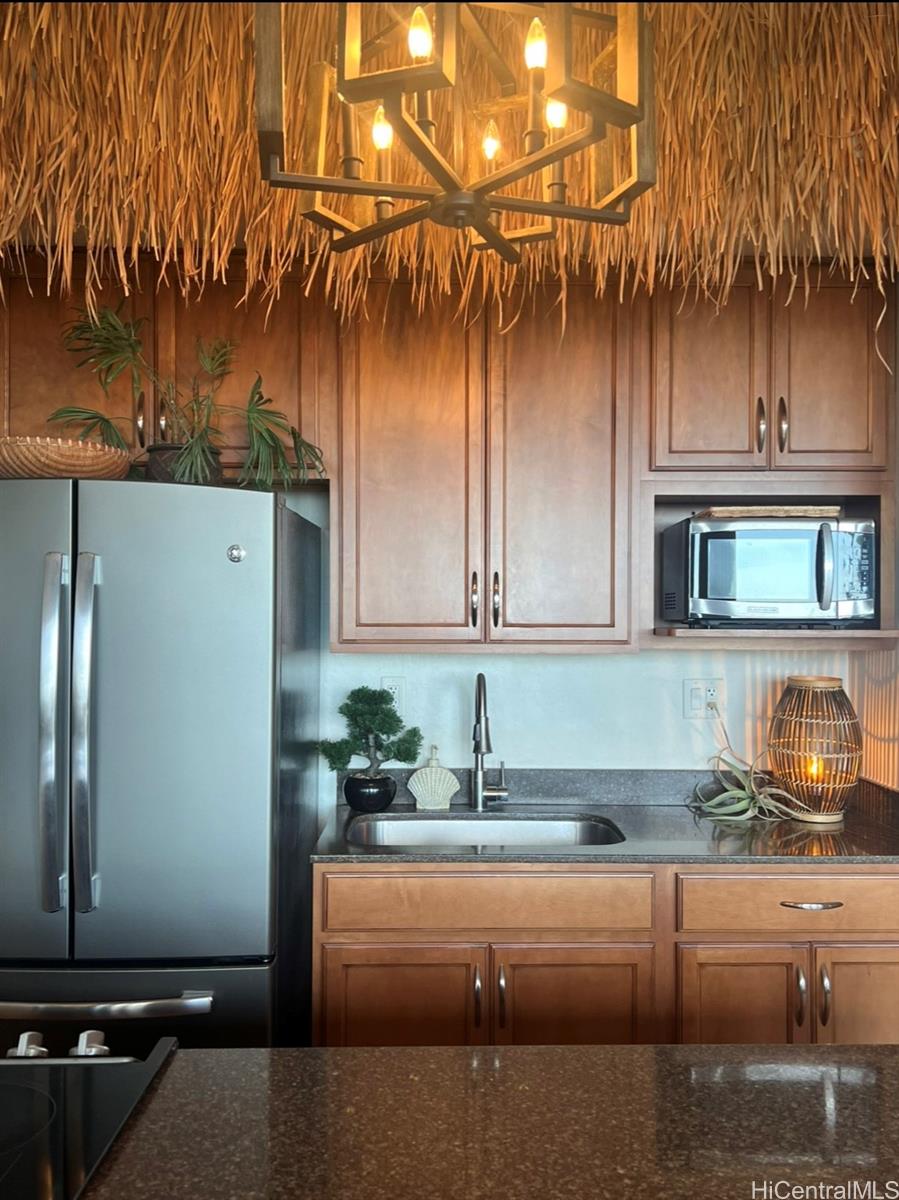 84-664 Ala Mahiku Street, Unit 194C Waianae, HI 96792 - Photo 11 of 25 a kitchen with a sink and a refrigerator