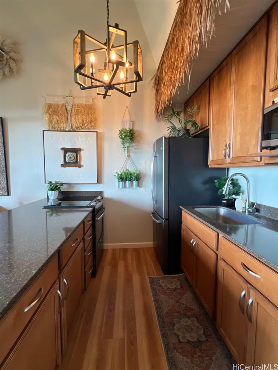 84-664 Ala Mahiku Street, Unit 194C Waianae, HI 96792 - Photo 12 of 25 a kitchen with stainless steel appliances a sink and a refrigerator