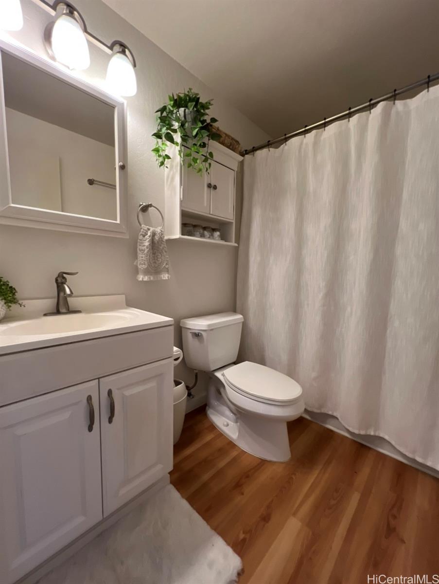 84-664 Ala Mahiku Street, Unit 194C Waianae, HI 96792 - Photo 14 of 25 a bathroom with a sink a toilet and shower curtain