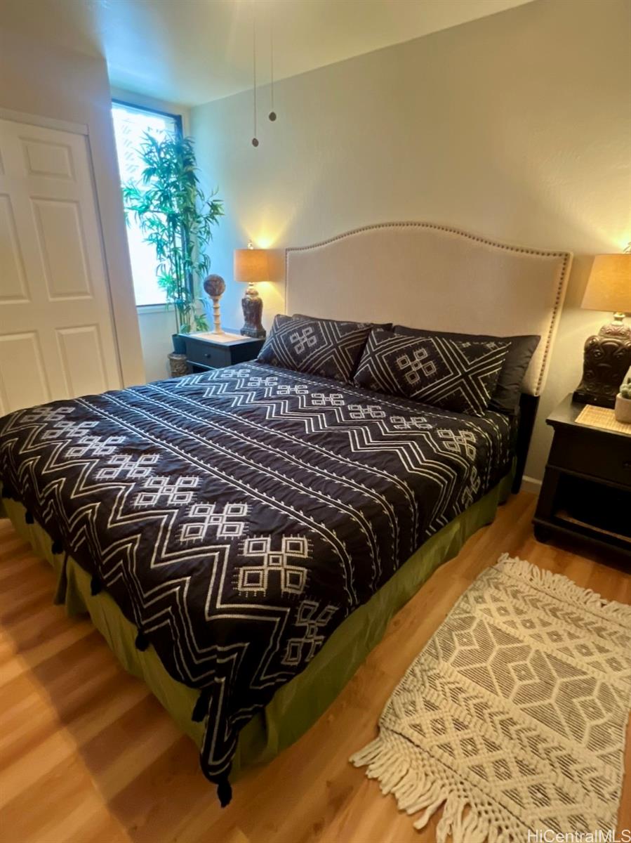 84-664 Ala Mahiku Street, Unit 194C Waianae, HI 96792 - Photo 15 of 25 a bed sitting in a bedroom next to a window