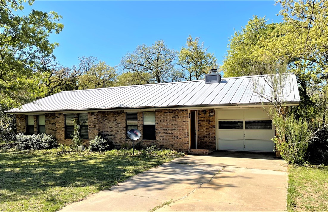 214 Flint Ridge Street Bastrop, TX 78602 - Photo 1 of 1 3 bedroom, 2 bathroom, brick home with a metal roof on .727 acre.