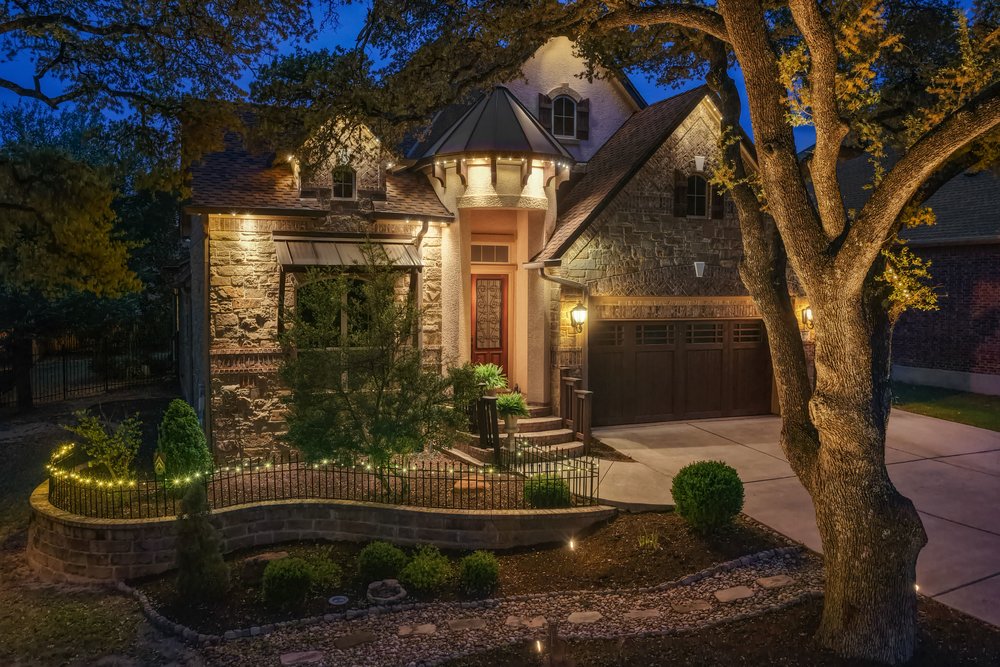 Flanked by stately oak trees, this home stands out among its neighbors.