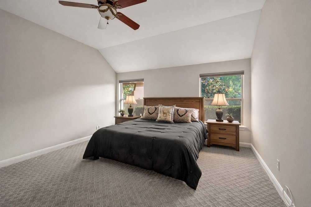 1589 Cool Spring Way Austin, TX 78737 - Photo 14 of 32 The large primary bedroom has ample space for a king-size bed, night stands, dresser and more.