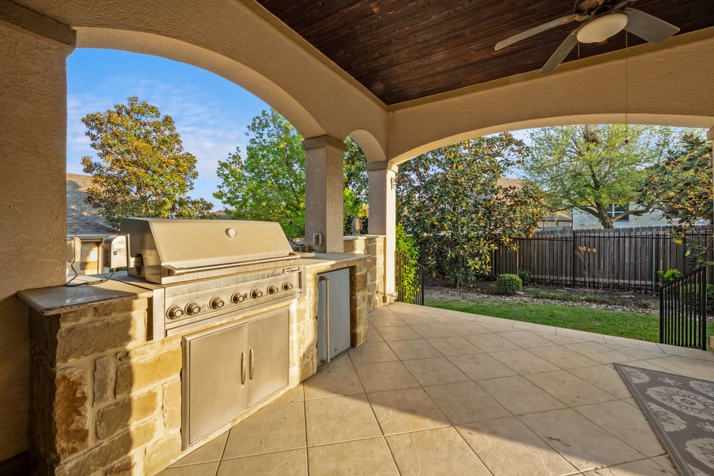 1589 Cool Spring Way Austin, TX 78737 - Photo 23 of 32 The built-in outdoor kitchen is a key feature of this oversized back patio.