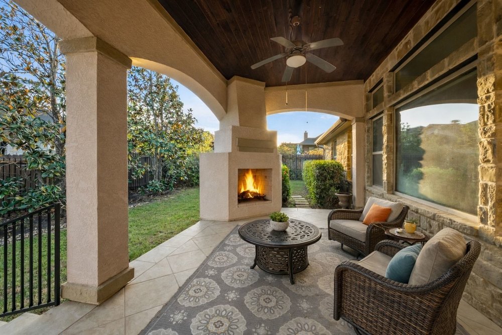 1589 Cool Spring Way Austin, TX 78737 - Photo 25 of 32 The large back patio with fireplace and plenty of room to relax as shown in this virtually staged photo.