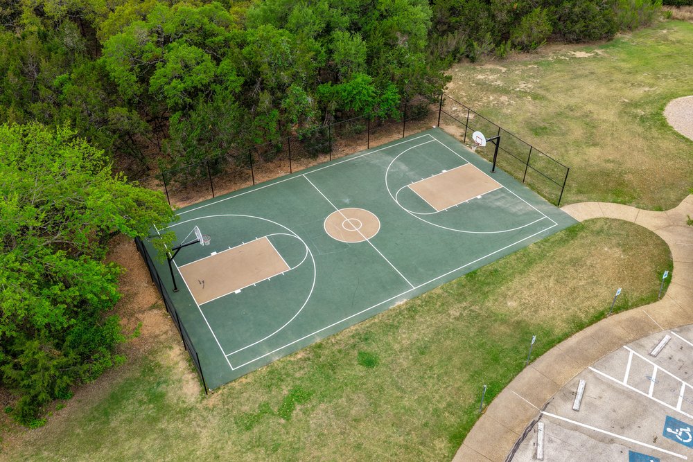 1589 Cool Spring Way Austin, TX 78737 - Photo 31 of 32 Highpointe features a variety of amenities including a basketball court.