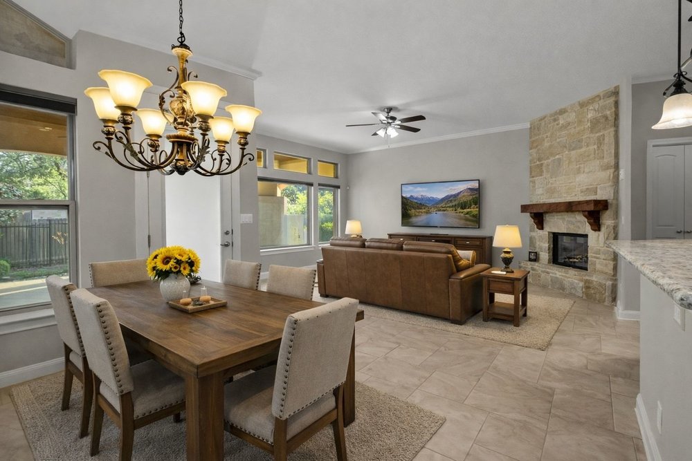 1589 Cool Spring Way Austin, TX 78737 - Photo 8 of 32 This virtually staged, open concept living and dining area features a large fireplace.