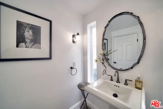 a balcony with table and chairs and wooden floor