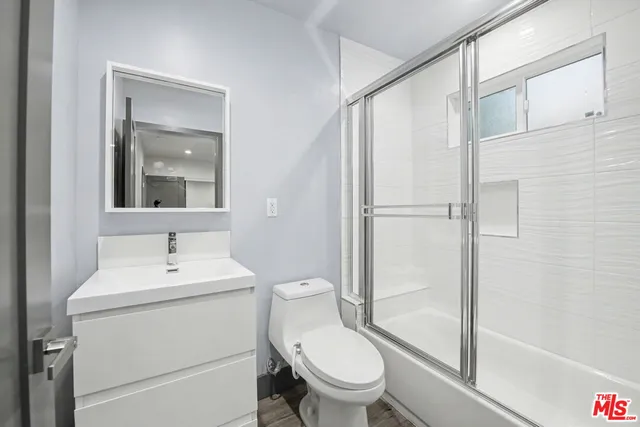 a white toilet sitting next to a bathroom sink