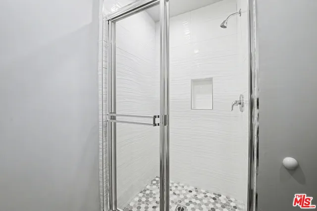 a bathroom with a glass shower door