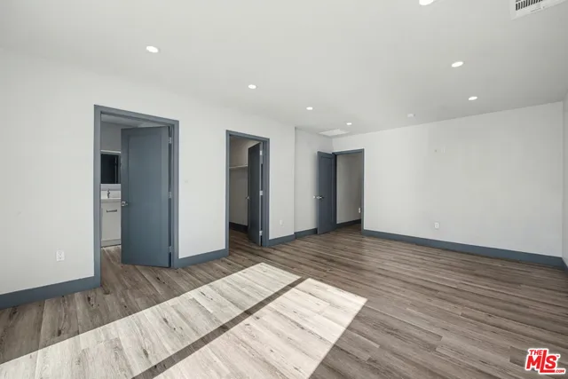 a view of an empty room and wooden floor