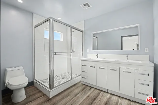 a bathroom with a toilet a sink and mirror