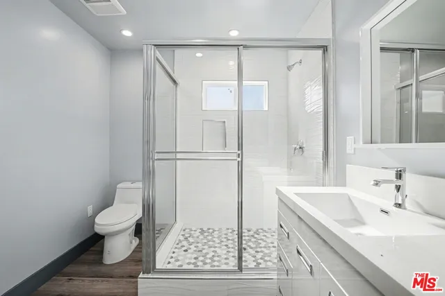 a bathroom with a sink toilet and shower