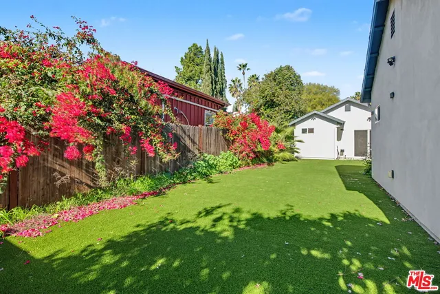 a view of a house with a big yard and garden
