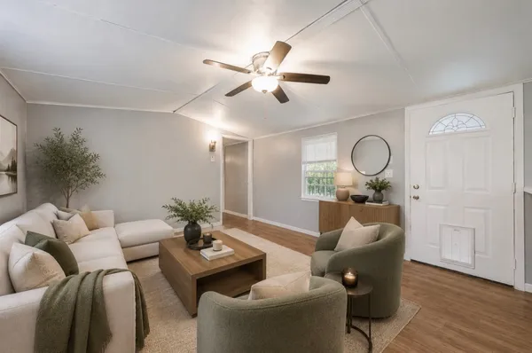 a living room with furniture and a large mirror