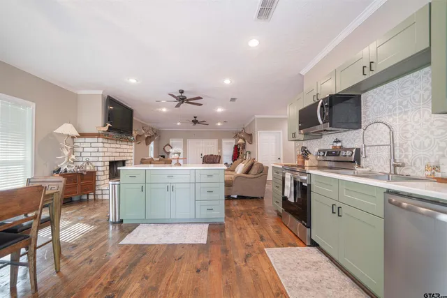 a kitchen with a refrigerator sink and cabinets