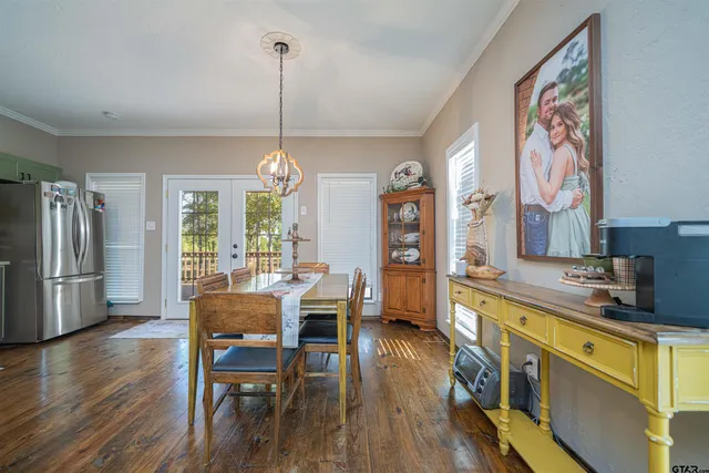 a bedroom with a bed and a flat tv screen on dresser
