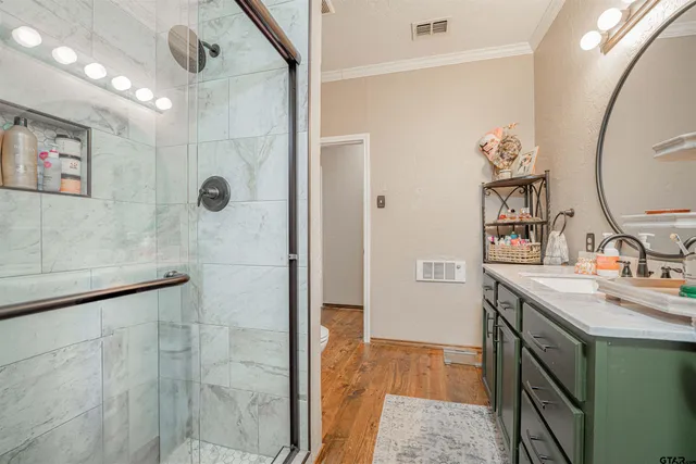 a bathroom with a toilet a sink and a mirror