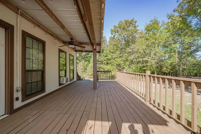 a kitchen with stainless steel appliances a dining table chairs stove refrigerator and cabinets